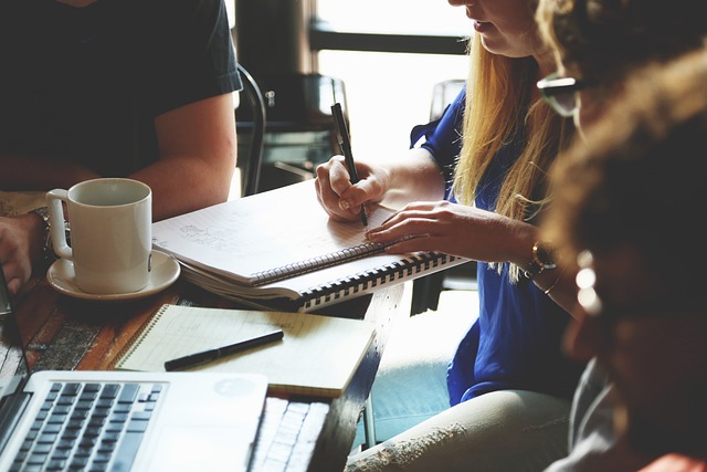 people working together and taking notes